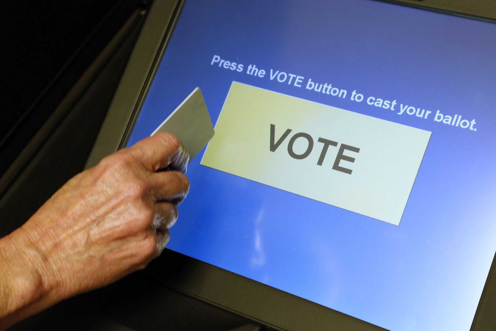 An elections official demonstrates a touch-screen voting machine at the Fairfax County Governmental Center in Fairfax, Virginia, U.S. on October 3, 2012. REUTERS/Jonathan Ernst/File Photo