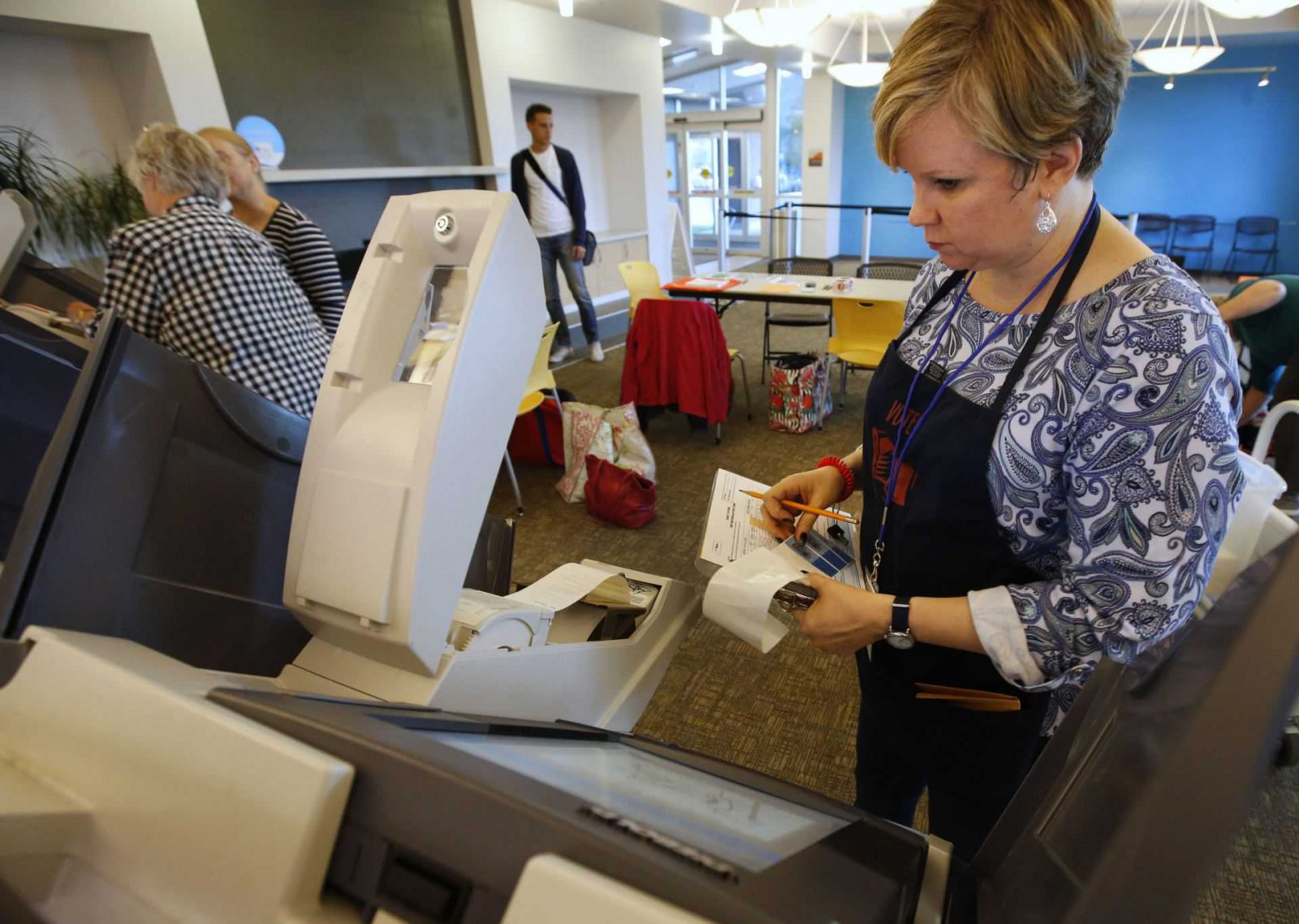 PROVO, UT - OCTOBER 25: Poll worker, Heather Uppencamp, sets up a voting machine for the first day of early voting at the Provo Recreation Center on October 25, 2016 in Provo, Utah. Early voting in the 2016 presidential election for Utah residents begins October 25 and ends November 4. George Frey/Getty Images/AFP == FOR NEWSPAPERS, INTERNET, TELCOS & TELEVISION USE ONLY ==